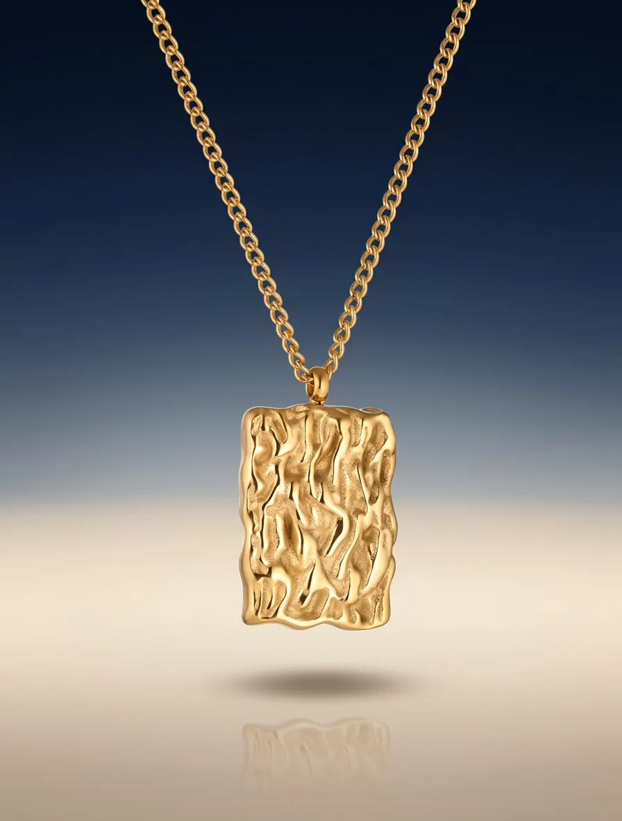 Gold chain necklace with a textured pendant